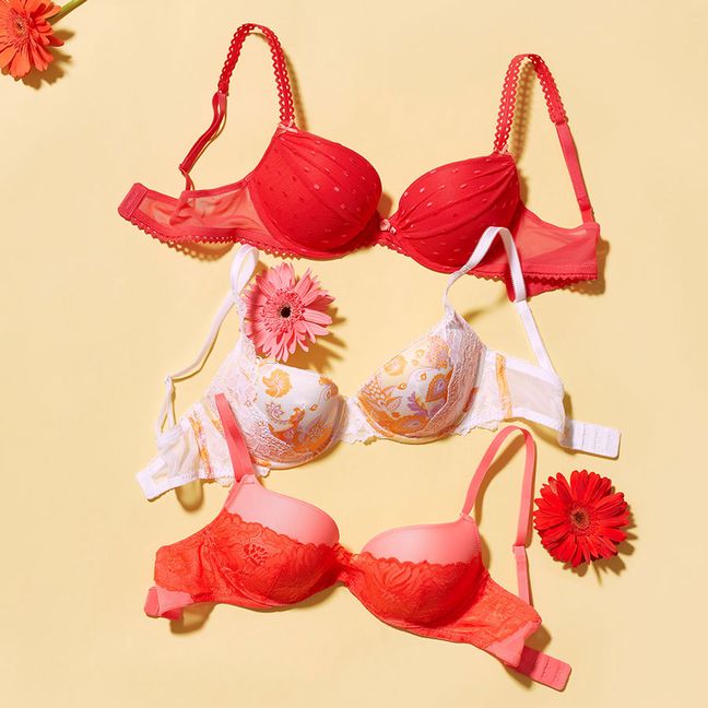 Two red Adore Me bras and one white Adore Me bra